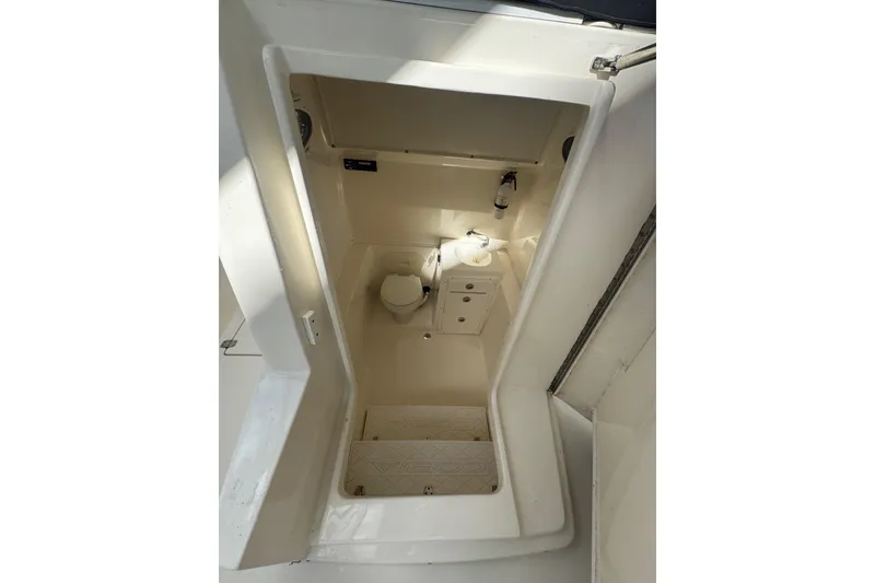 Slide: The Image of 2014 Cobia 296 Center Console boat interior with toilet and sink. - 22