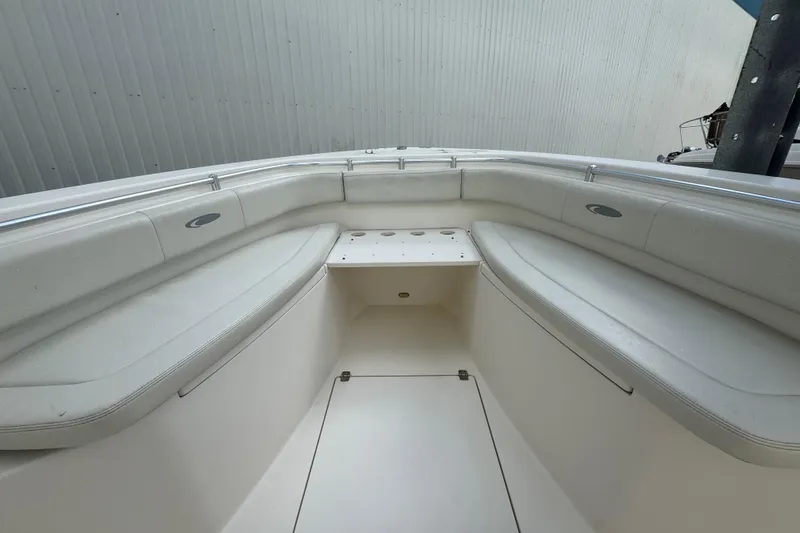 Slide: The Image of 2014 Cobia 296 Center Console boat interior with white seating and storage. - 24