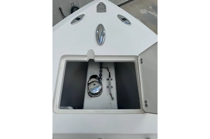Slide: The Image of 2014 Cobia 296 Center Console anchor compartment with chain and cleat. - 25