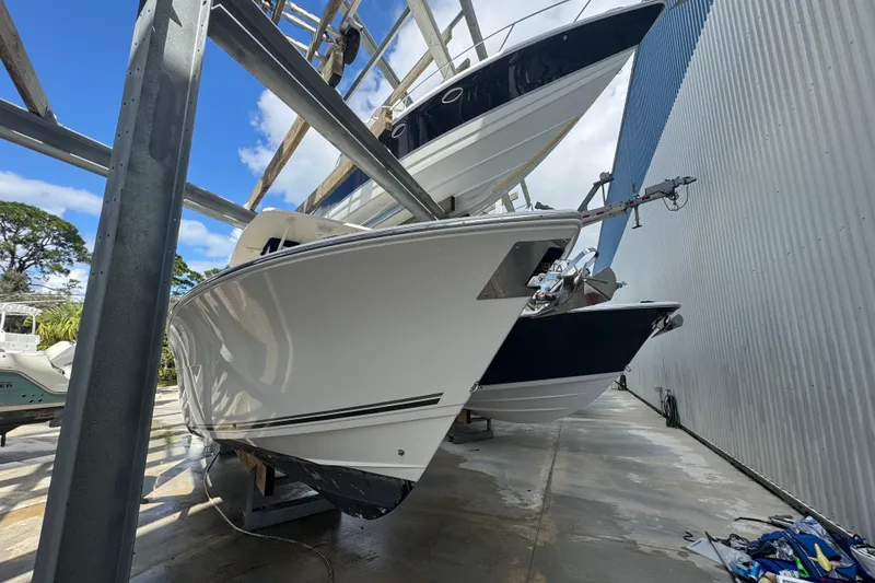 Slide: The Image of 2014 Cobia 296 Center Console boat stored in a dry dock facility. - 3