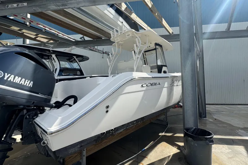 Slide: The Image of 2014 Cobia 296 Center Console boat with Yamaha engine in storage. - 5