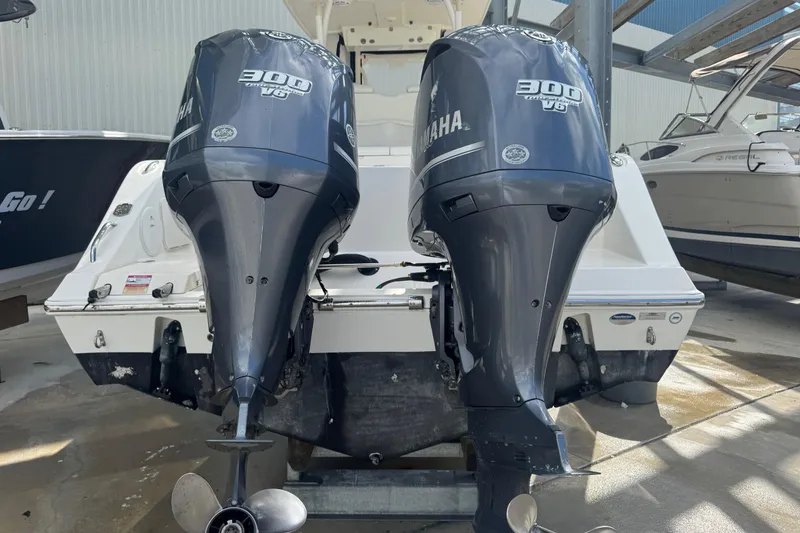 Slide: The Image of 2014 Cobia 296 Center Console with twin Yamaha 300 V6 outboard engines. - 6