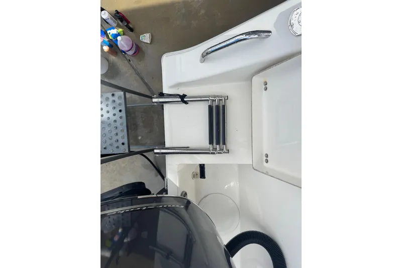 Slide: The Image of 2014 Cobia 296 Center Console boat with folded ladder and clean deck area. - 7