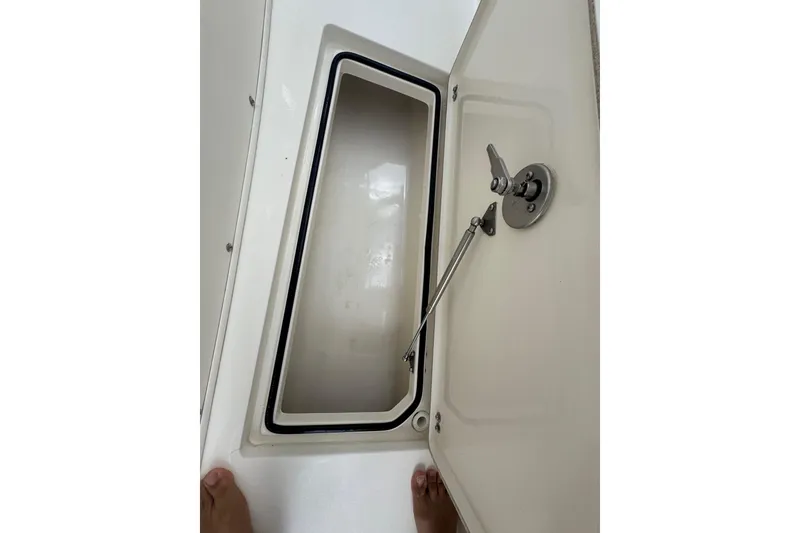 Slide: The Image of Open storage compartment on a 2014 Cobia 296 Center Console boat. - 9