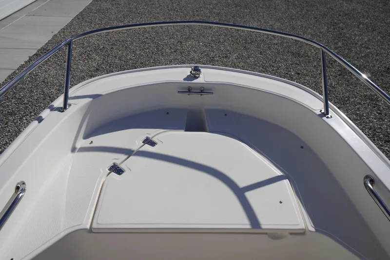 Slide: The Image of 2023 Boston Whaler 130 Super Sport boat deck with stainless steel railings. - 26