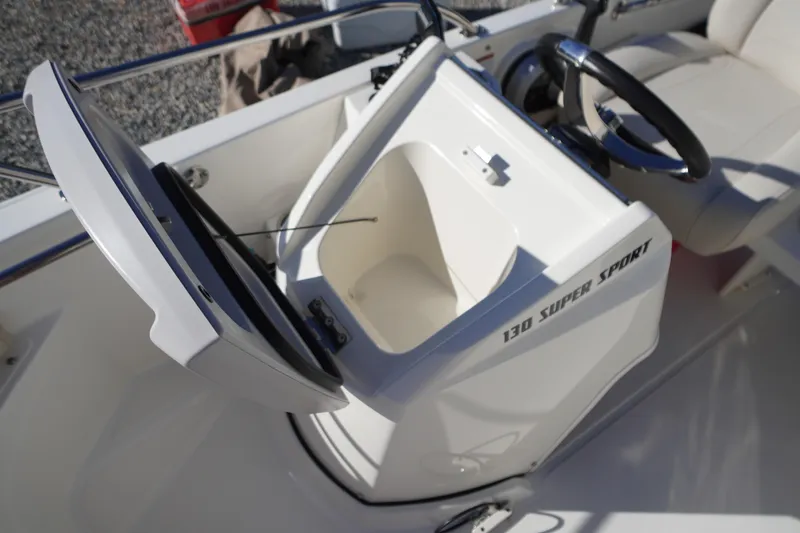 Slide: The Image of 2023 Boston Whaler 130 Super Sport boat interior with open storage compartment. - 29