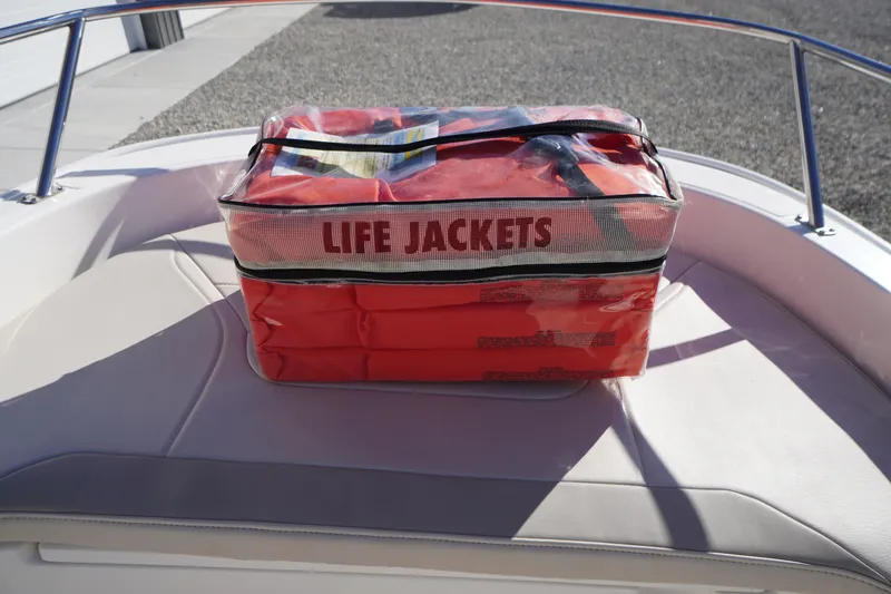 Slide: The Image of Life jackets on a 2023 Boston Whaler 130 Super Sport boat seat. - 40