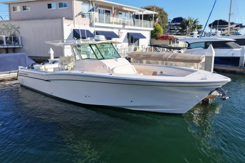 The Image of 2014 Grady-White Canyon 376 boat docked in marina, clear day, waterfront view. - 0
