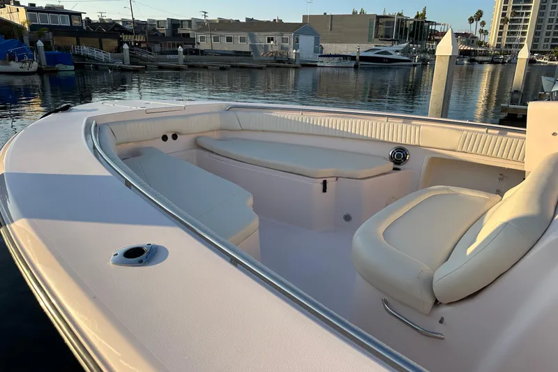 Slide: The Image of 2014 Grady-White Canyon 376 boat interior with seating, docked in a marina. - 11