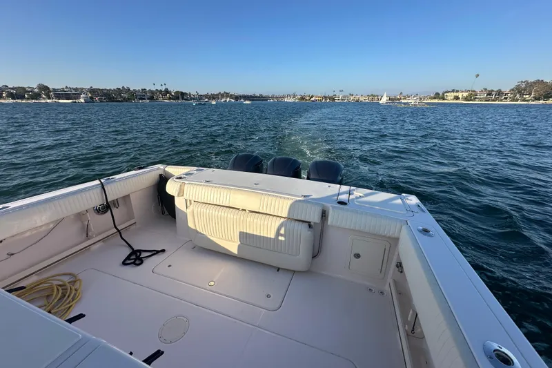 Slide: The Image of 2014 Grady-White Canyon 376 boat on water, scenic coastal view. - 16