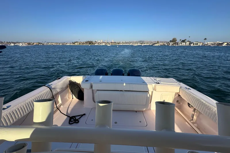 Slide: The Image of 2014 Grady-White Canyon 376 boat on calm water with scenic coastal view. - 18