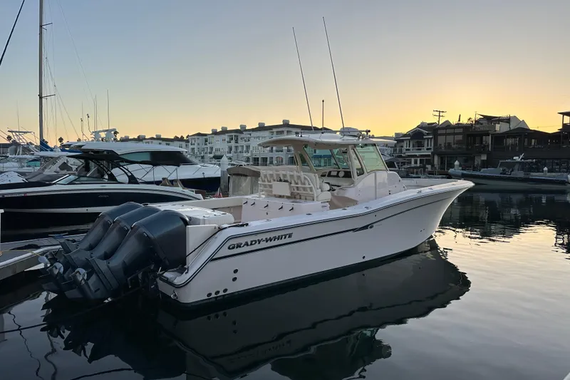 Slide: The Image of 2014 Grady-White Canyon 376 boat docked at sunset in a marina. - 20