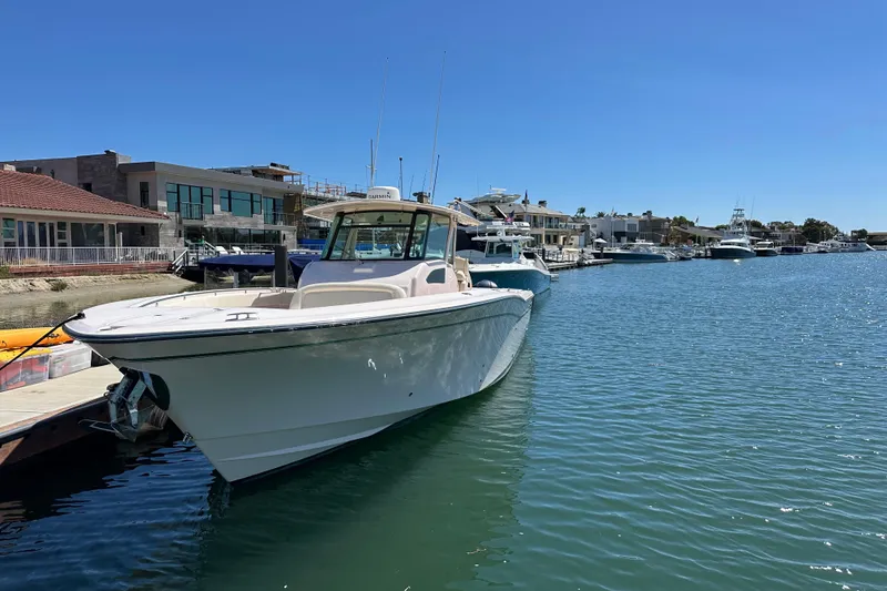 Slide: The Image of 2014 Grady-White Canyon 376 boat docked in a sunny marina. - 22