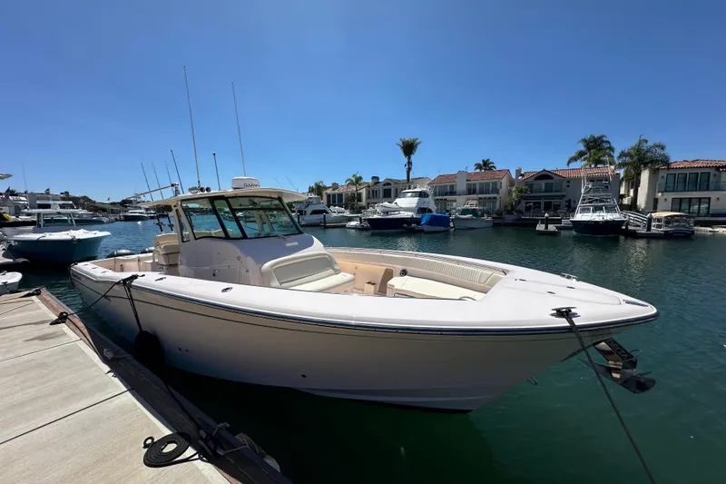 Slide: The Image of 2014 Grady-White Canyon 376 boat docked in a sunny marina setting. - 27