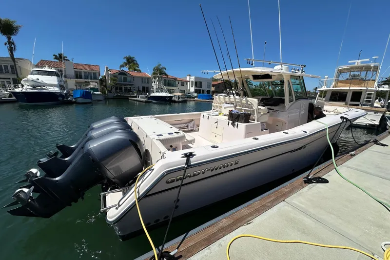 Slide: The Image of 2014 Grady-White Canyon 376 boat docked in a marina under clear blue skies. - 28