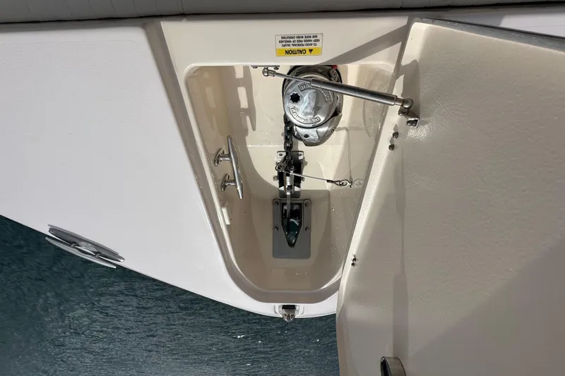 Slide: The Image of Anchor compartment of 2014 Grady-White Canyon 376 boat, featuring winch and hardware. - 29