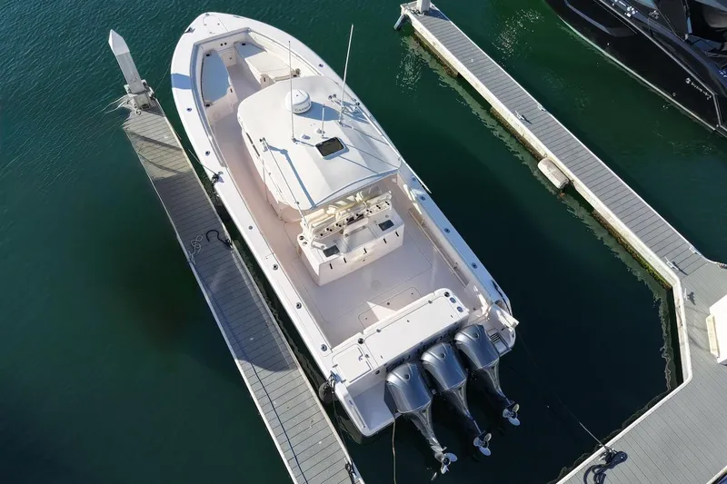 Slide: The Image of 2014 Grady-White Canyon 376 boat docked, aerial view, triple engines visible. - 3