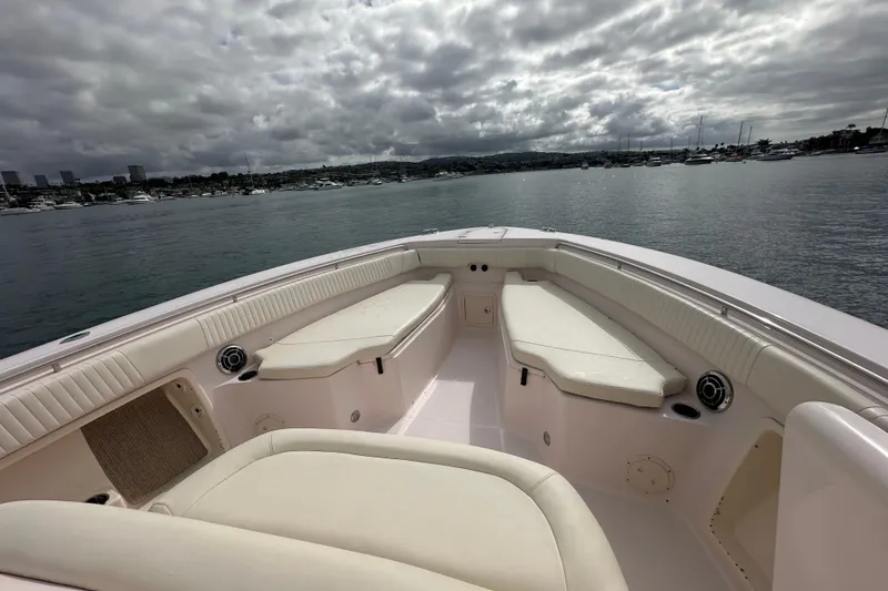 Slide: The Image of 2014 Grady-White Canyon 376 boat interior with seating, overlooking a marina. - 31