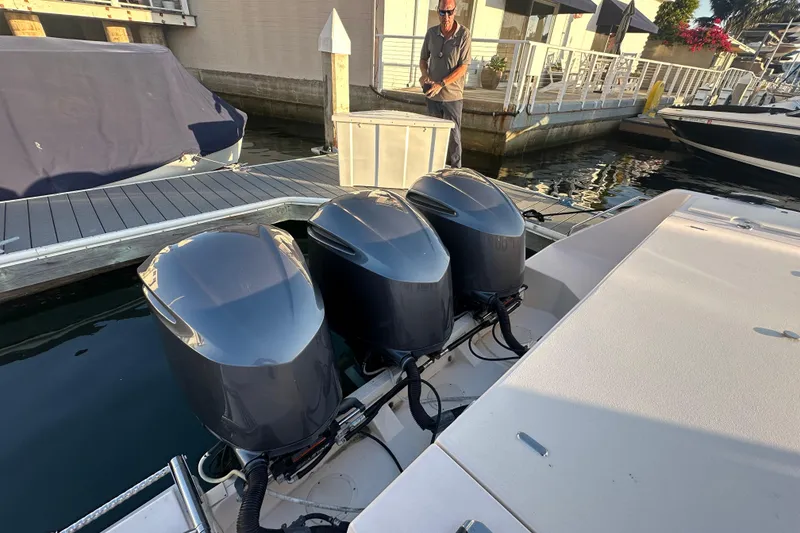 Slide: The Image of 2014 Grady-White Canyon 376 with triple outboard engines docked at marina. - 7