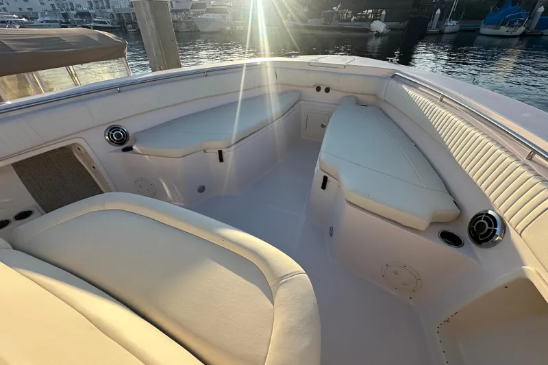 Slide: The Image of 2014 Grady-White Canyon 376 boat interior with cushioned seating and waterfront view. - 8