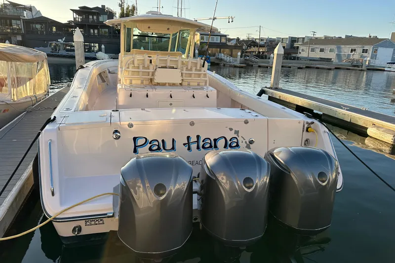Slide: The Image of 2014 Grady-White Canyon 376 boat docked with triple outboard engines. - 9