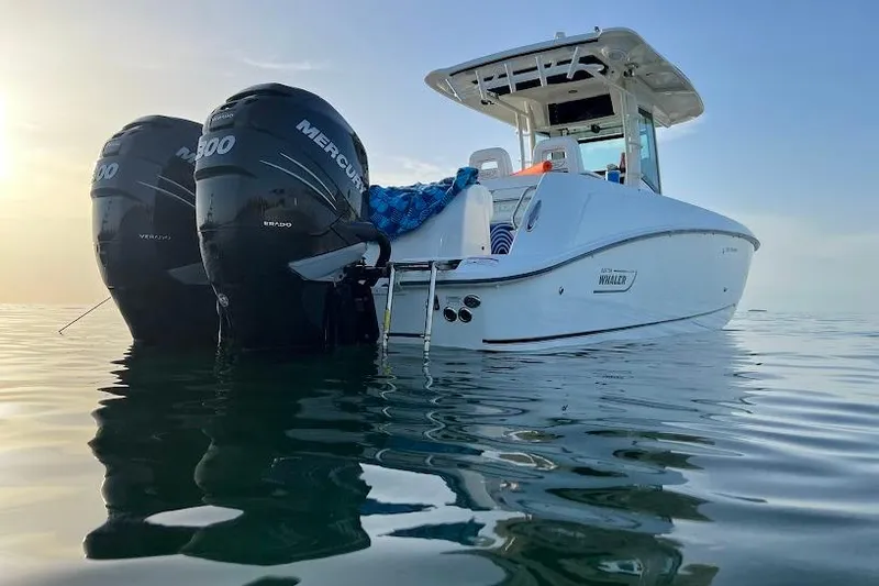The Image of 2016 Boston Whaler 320 Outrage boat with twin Mercury engines on calm water. - 0