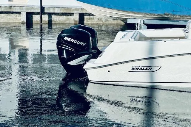 Slide: The Image of 2016 Boston Whaler 320 Outrage with Mercury engine docked on calm water. - 16