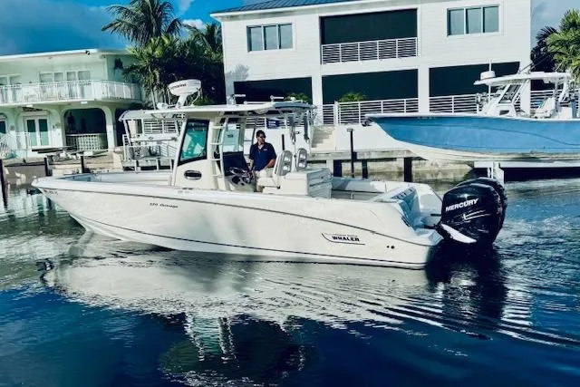 Slide: The Image of 2016 Boston Whaler 320 Outrage boat docked near waterfront homes. - 18