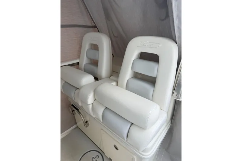 Slide: The Image of 2016 Boston Whaler 320 Outrage boat seats, featuring white cushioned design. - 2