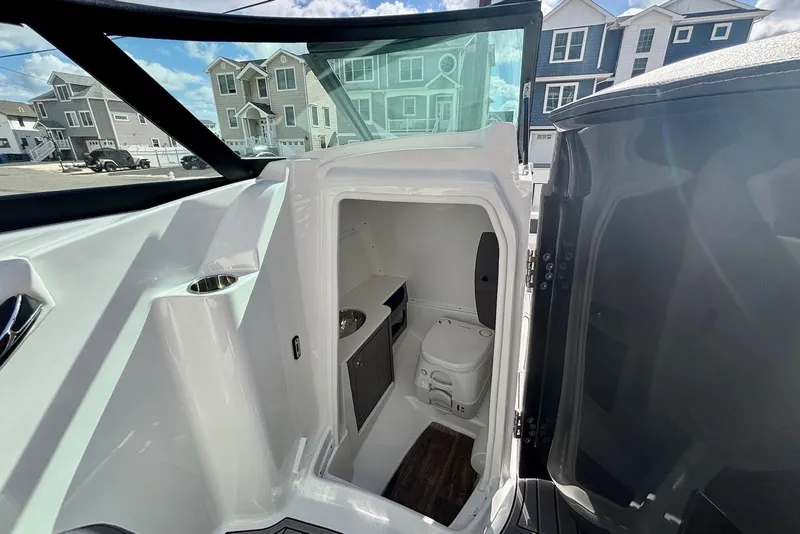 Slide: The Image of 2021 Monterey M-65 boat interior with compact bathroom and modern amenities. - 16
