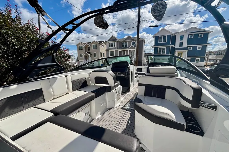 Slide: The Image of 2021 Monterey M-65 boat interior with luxurious seating and modern design under a blue sky. - 5