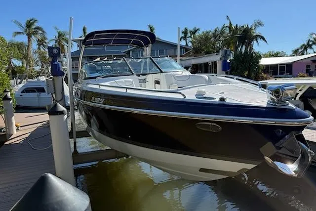 The Image of 2015 Formula 310 Bowrider boat docked, featuring sleek design and spacious deck. - 0