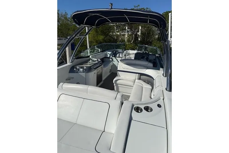 Slide: The Image of 2015 Formula 310 Bowrider boat interior with white seating and canopy. - 5