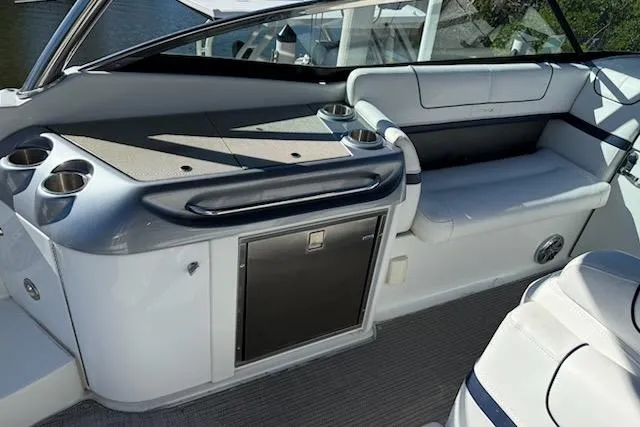 Slide: The Image of 2015 Formula 310 Bowrider interior with seating, cup holders, and storage. - 8
