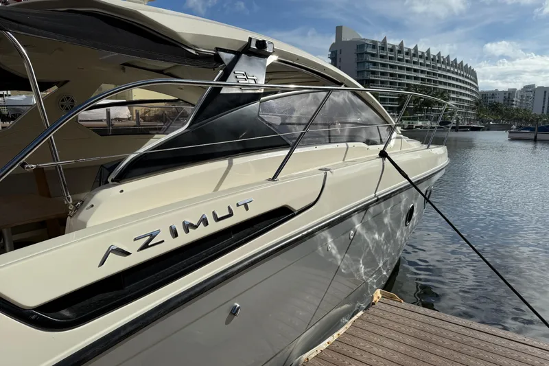 Slide: The Image of 2014 Azimut Atlantis 34 yacht docked at marina with modern architecture in background. - 3
