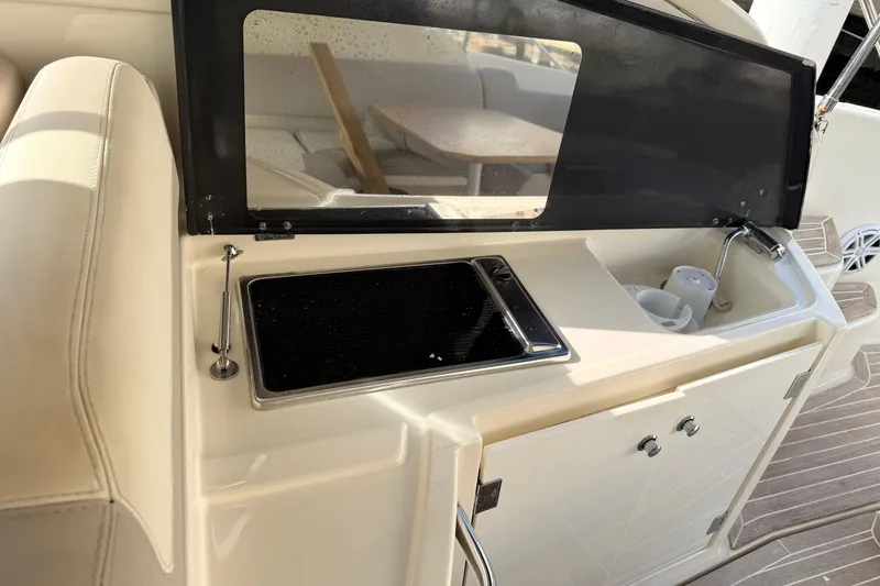 Slide: The Image of 2014 Azimut Atlantis 34 yacht kitchenette with sink and stove, featuring modern design. - 5