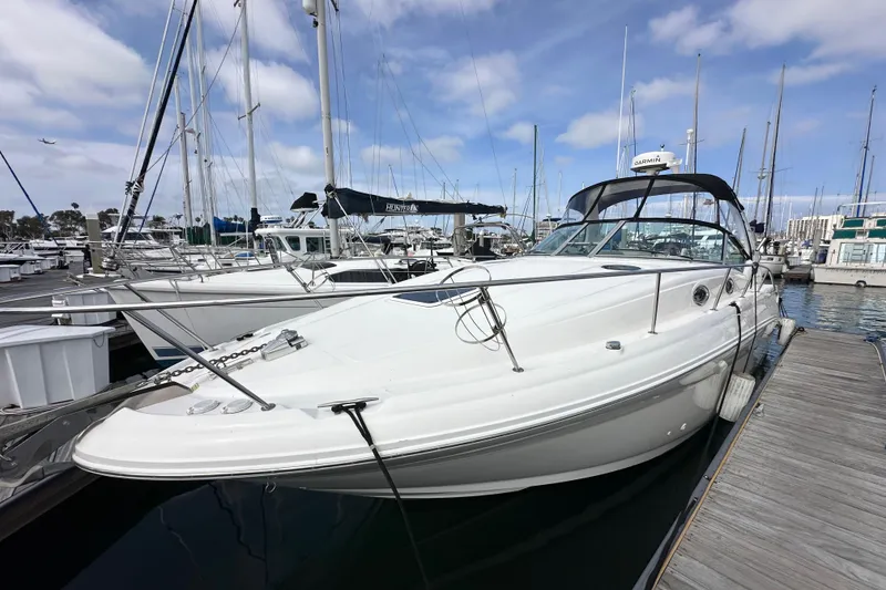 Slide: The Image of 2003 Sea Ray 320 Sundancer docked at marina under blue sky. - 1