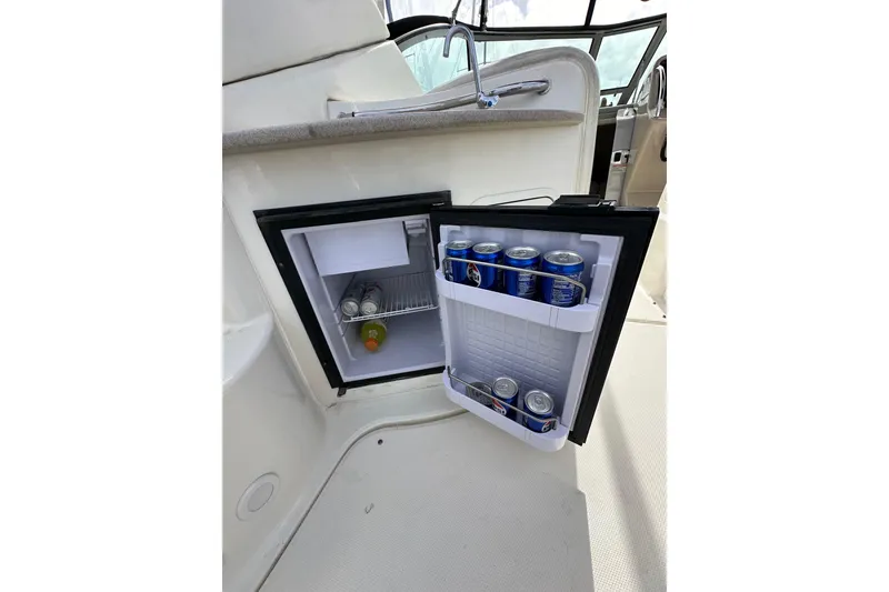 Slide: The Image of Mini fridge stocked with drinks on a 2003 Sea Ray 320 Sundancer boat. - 14
