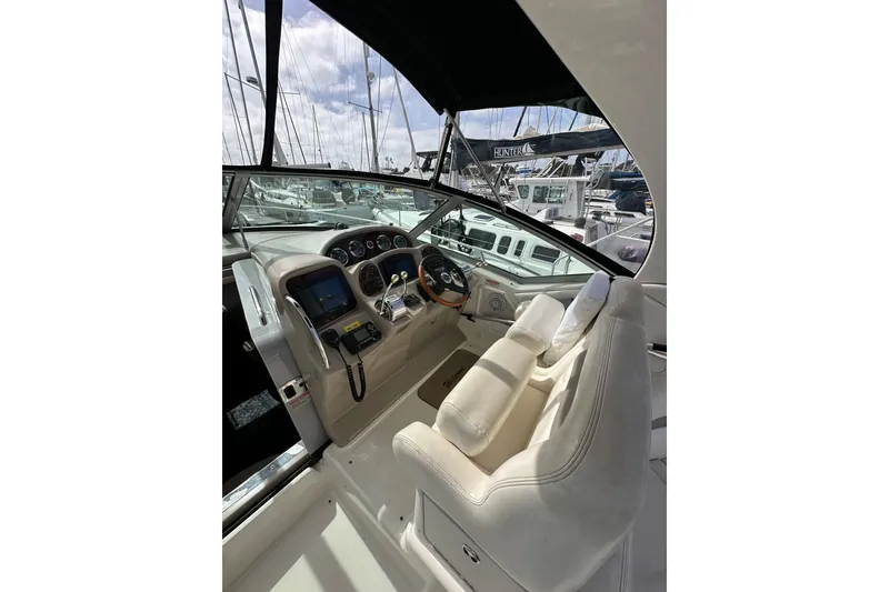 Slide: The Image of 2003 Sea Ray 320 Sundancer helm with modern controls and comfortable seating. - 17