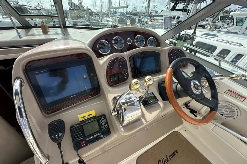 Slide: The Image of Helm of 2003 Sea Ray 320 Sundancer with navigation equipment and steering wheel. - 18