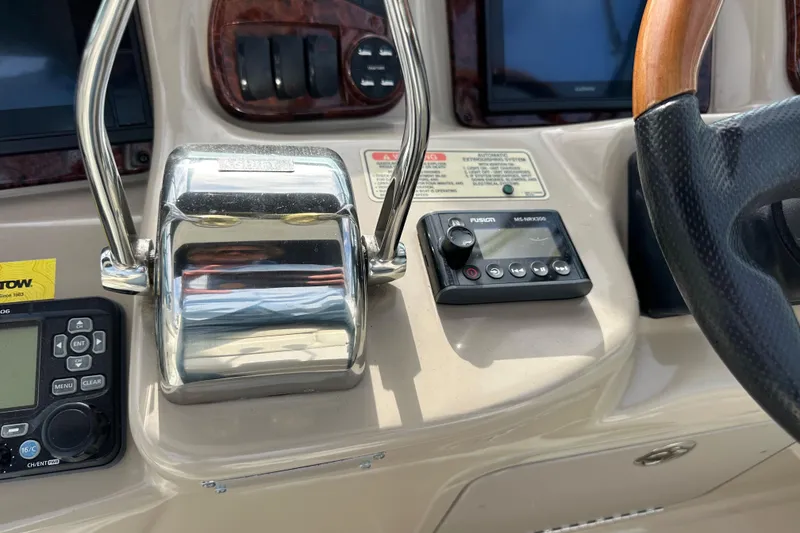 Slide: The Image of Control panel of a 2003 Sea Ray 320 Sundancer boat with steering wheel and throttle. - 20