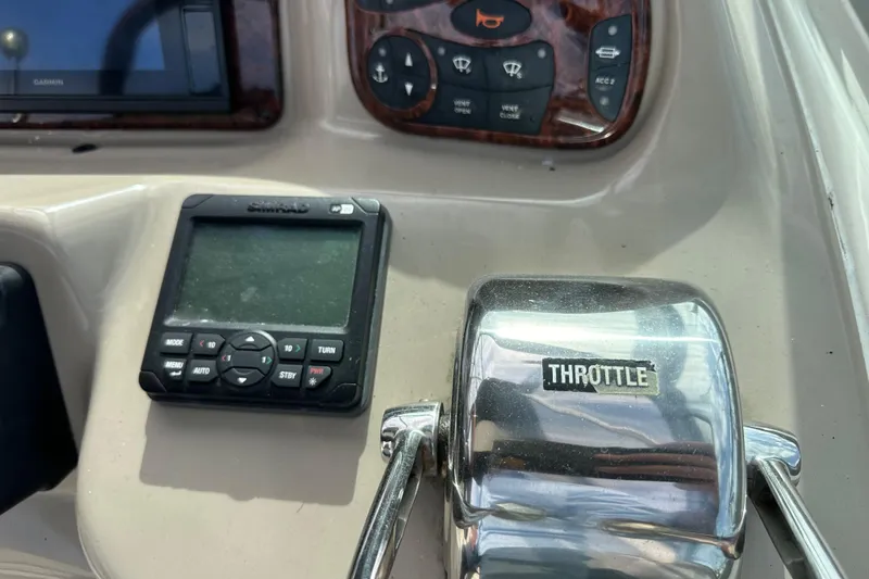 Slide: The Image of Throttle control and navigation panel on a 2003 Sea Ray 320 Sundancer boat. - 22