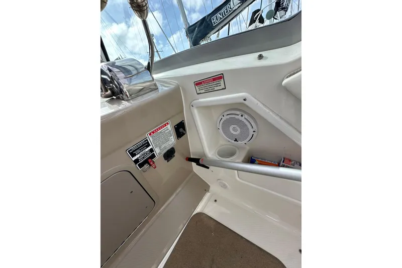 Slide: The Image of 2003 Sea Ray 320 Sundancer boat interior with speaker and safety warnings. - 23