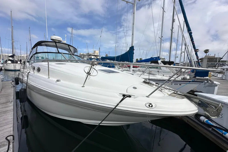 Slide: The Image of 2003 Sea Ray 320 Sundancer docked at marina under blue sky. - 3