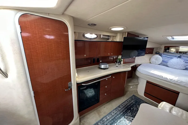 Slide: The Image of Luxurious interior of 2003 Sea Ray 320 Sundancer yacht with modern amenities and cozy sleeping area. - 30