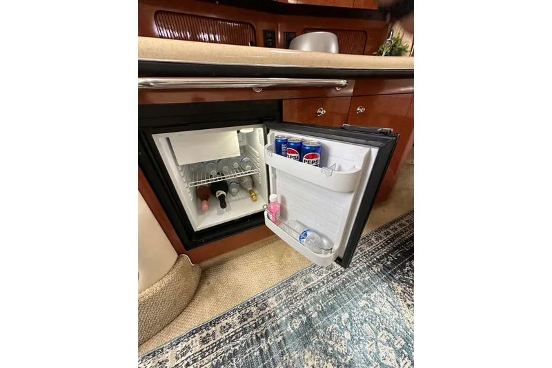 Slide: The Image of Mini fridge stocked with drinks inside a 2003 Sea Ray 320 Sundancer yacht. - 34