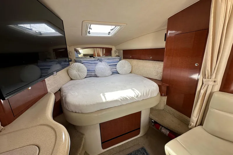 Slide: The Image of Interior of 2003 Sea Ray 320 Sundancer with cozy bed and elegant wood finish. - 39
