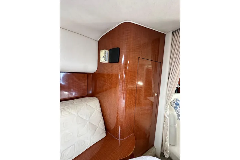 Slide: The Image of Interior of 2003 Sea Ray 320 Sundancer with wood paneling and upholstered seating. - 40