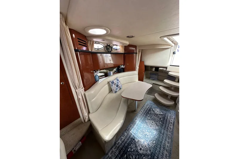 Slide: The Image of Interior of 2003 Sea Ray 320 Sundancer with elegant seating and nautical decor. - 42