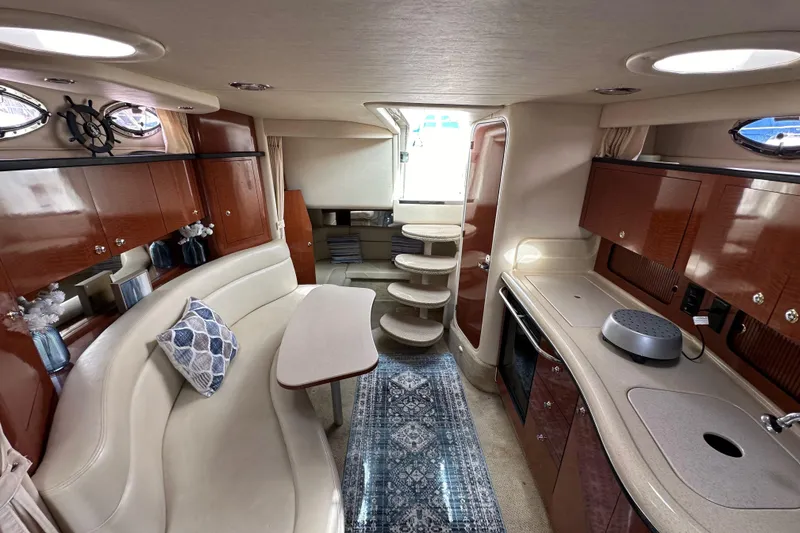 Slide: The Image of Luxurious interior of 2003 Sea Ray 320 Sundancer yacht with elegant seating and kitchenette. - 43